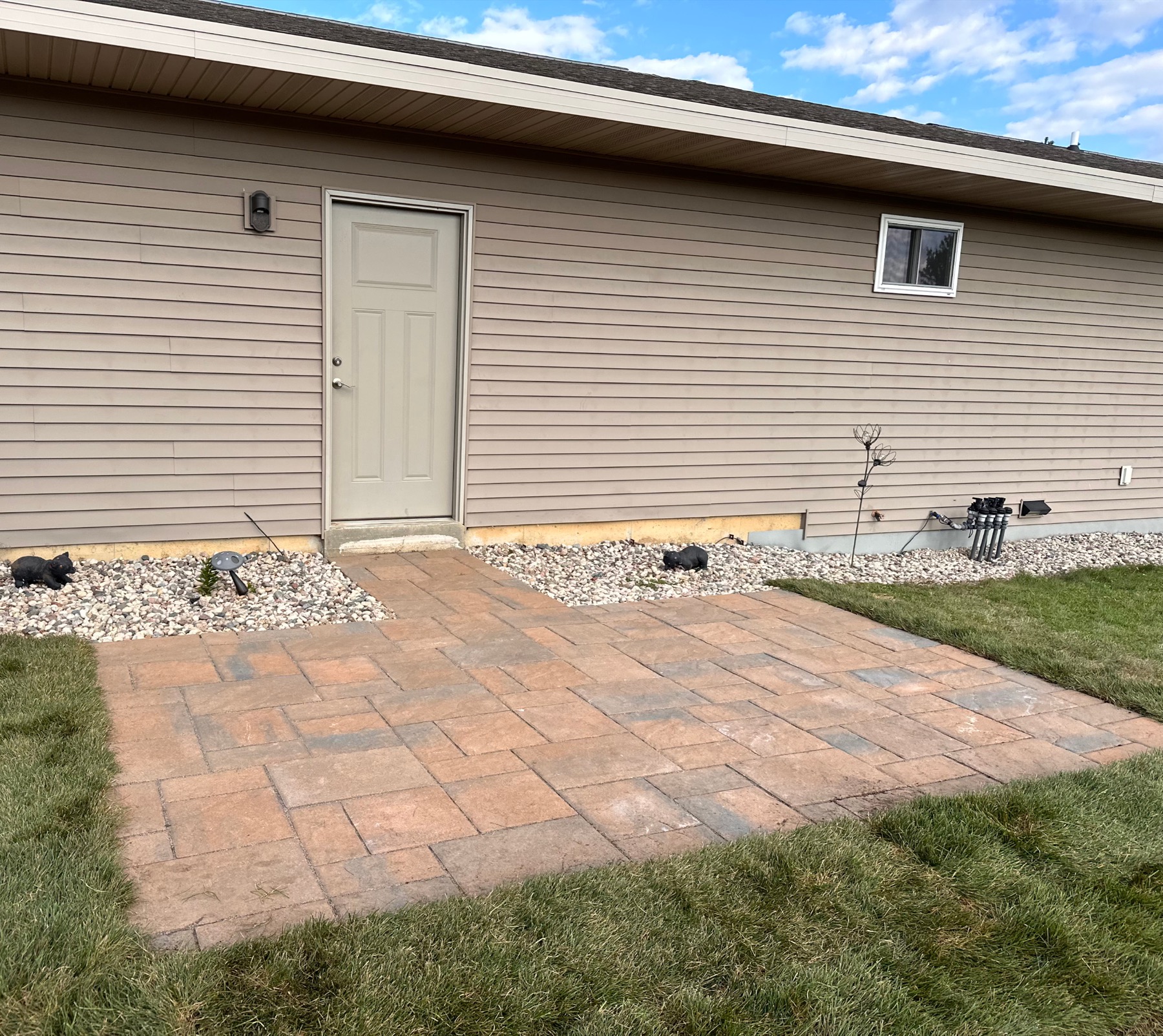 Finished paver patio beside a home